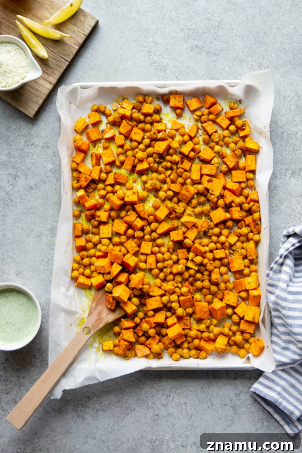 A beautifully arranged sweet potato chickpea shawarma bowl, showcasing the vibrant colors of fresh vegetables and the rich texture of the roasted components.
