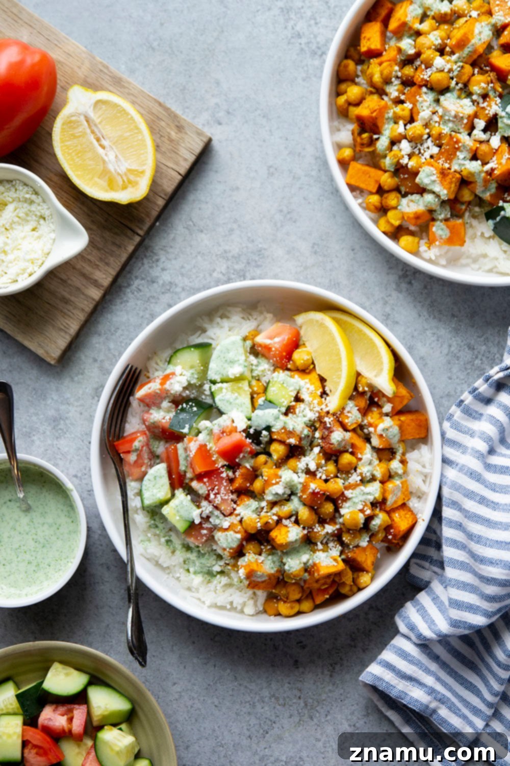 Ingredients for sweet potato chickpea shawarma bowls laid out, emphasizing fresh produce and spices.