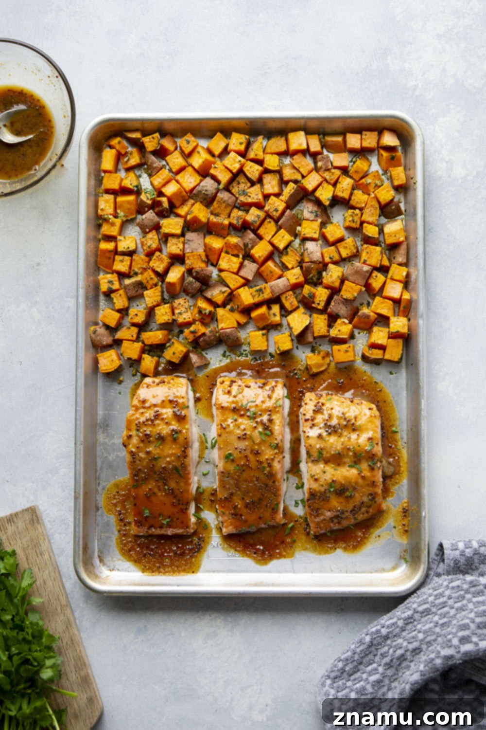 Honey Mustard Salmon with Garlic Butter Roasted Sweet Potatoes 4 Ingredients for honey mustard salmon and garlic butter sweet potatoes laid out on a kitchen counter.