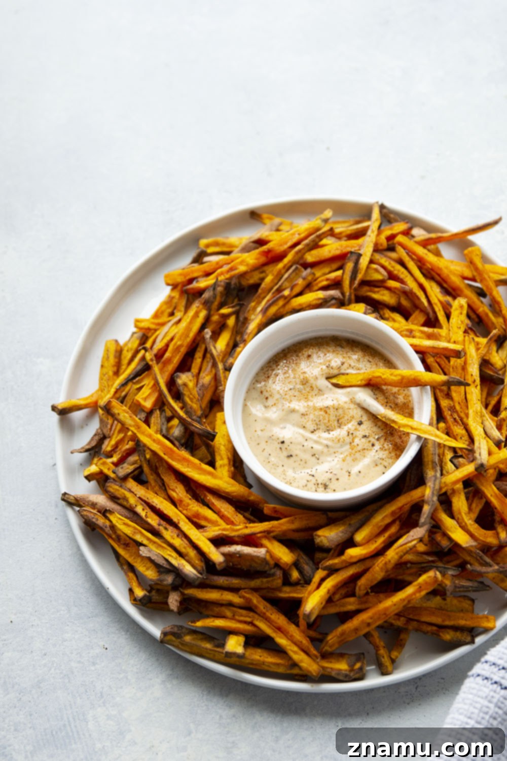 Crispy Air Fryer Sweet Potato Fries with Creamy Chipotle Aioli 6 Plate of Air Fryer Sweet Potato Fries with a side of Chipotle Aioli