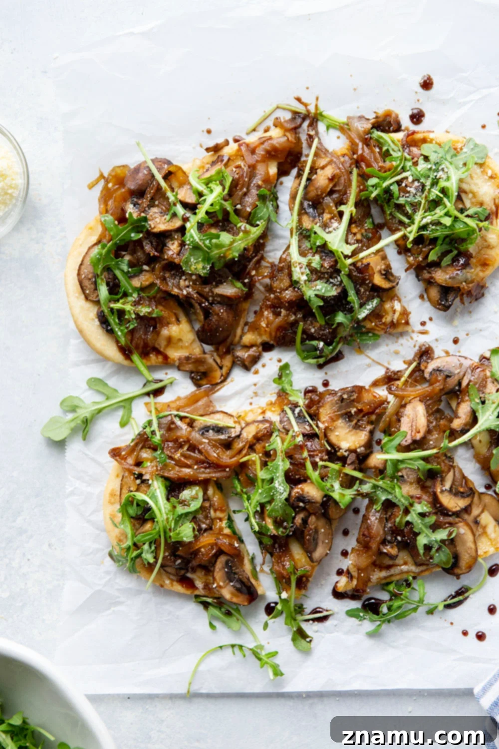 Sautéed caramelized onions and mushrooms simmering in a skillet, showcasing the deep golden color of the onions.