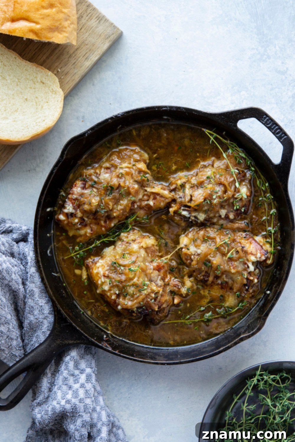 Golden brown French onion chicken thighs in a rich broth