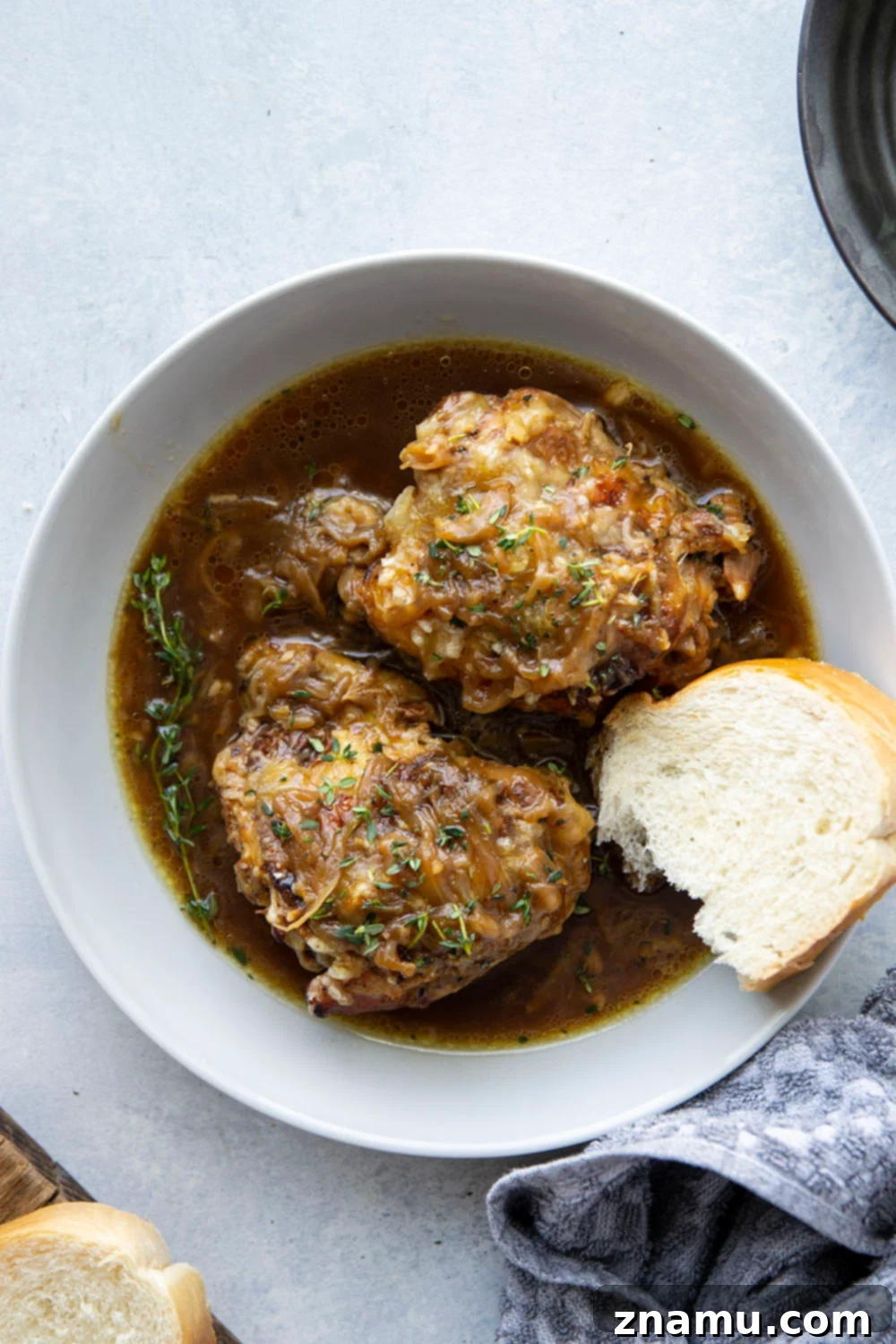 Braised chicken thighs with caramelized onions and melted Swiss cheese