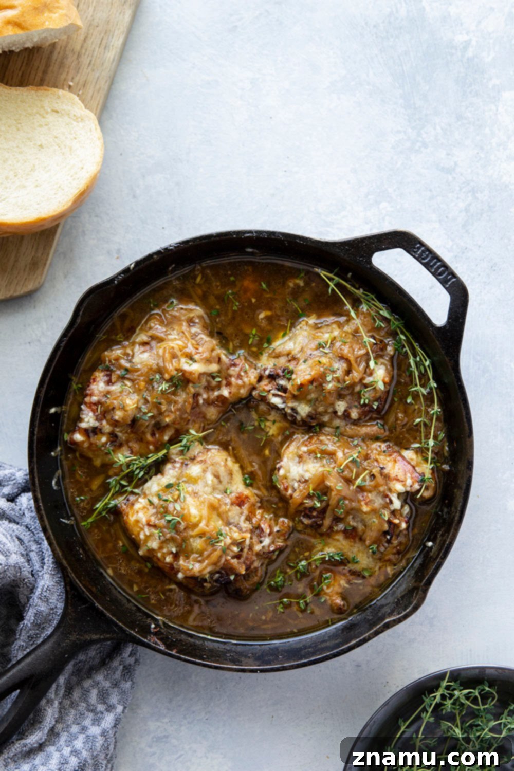 French onion chicken thighs ready to be served with crusty bread
