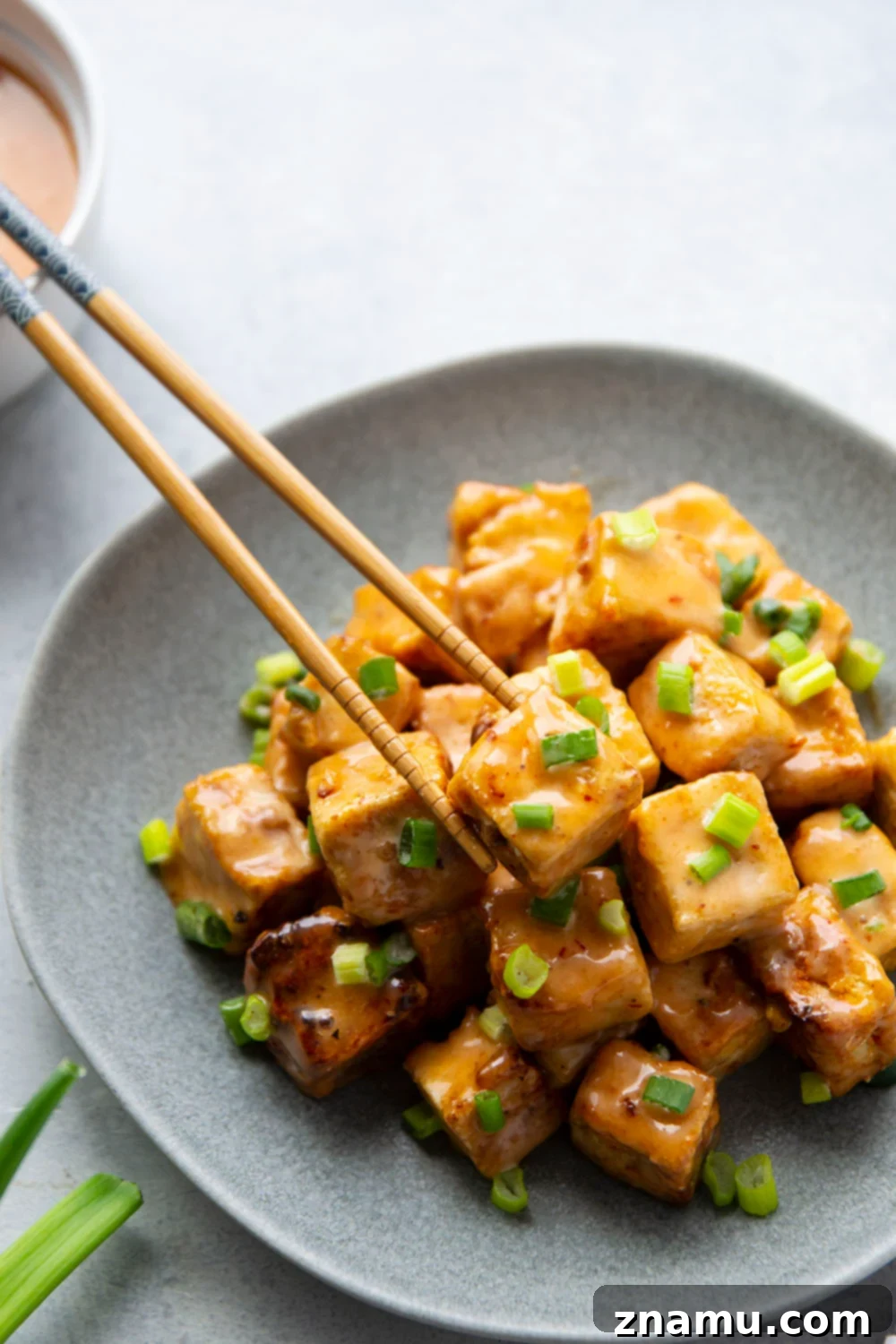 Crispy Air Fryer Bang Bang Tofu 3 Close-up of golden-brown Air Fryer Bang Bang Tofu cubes in a serving bowl