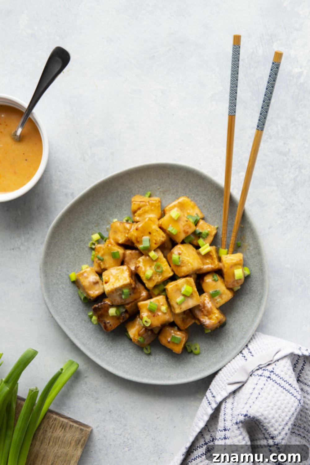 Crispy Air Fryer Bang Bang Tofu 6 A vibrant bowl of Air Fryer Bang Bang Tofu ready to be served, garnished with fresh scallions