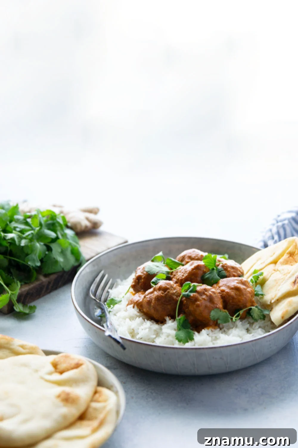 Creamy Instant Pot Butter Chicken Meatballs 5 A delicious bowl of Instant Pot Butter Chicken Meatballs with cilantro, ready to be served over rice.