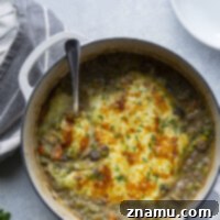 Flavorful Leek Mushroom Shepherd's Pie with golden mashed potato topping and melted white cheddar cheese, a perfect comfort food recipe.