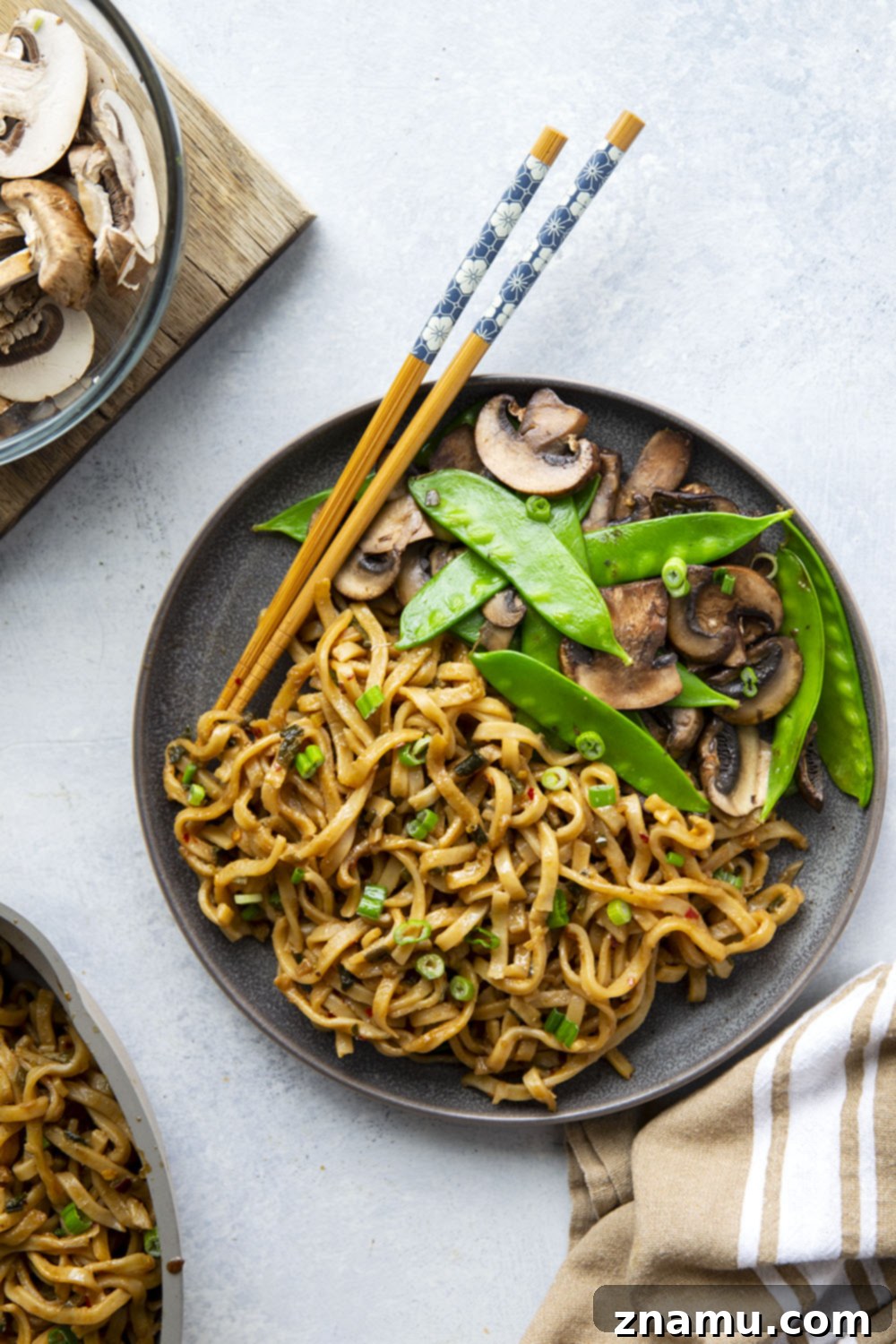 Fiery Miso Scallion Noodles 6 A large serving of spicy scallion miso noodles in a black bowl, ready to be enjoyed, showcasing the vibrant sauce and vegetables.