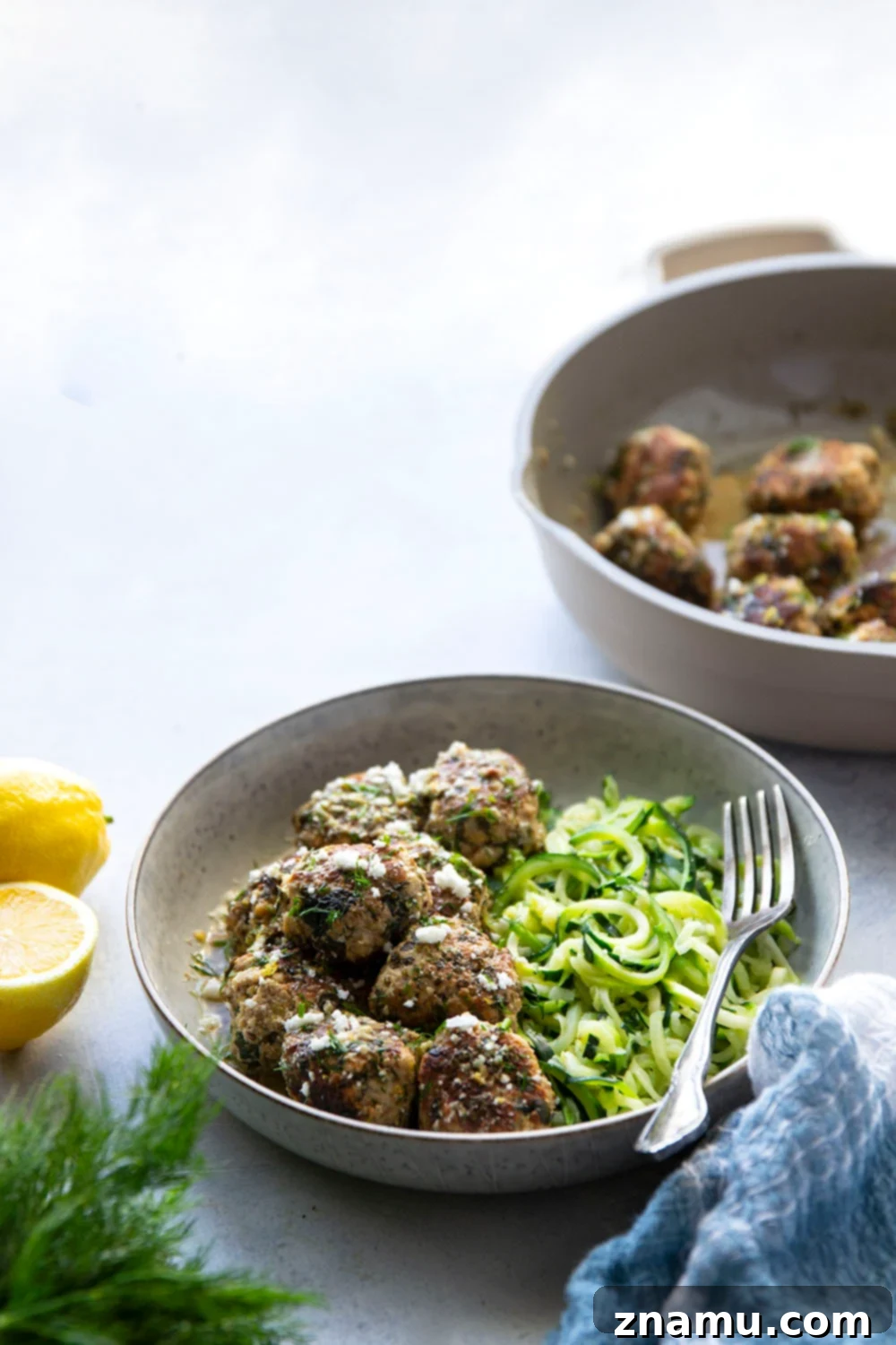 Zesty Lemon Dill Chicken Meatballs with Spinach and Feta 5 A bowl of fresh ingredients: ground chicken, spinach, feta, breadcrumbs, and egg, ready for meatball preparation.