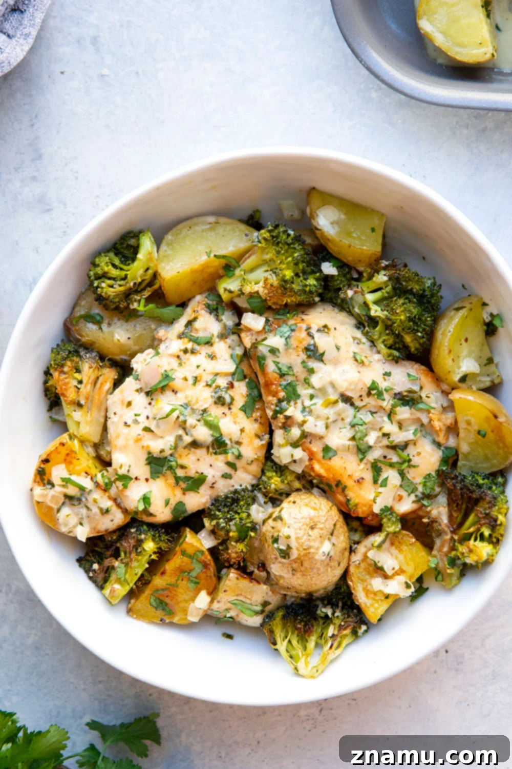 Flavorful Cilantro Lime Chicken & Roasted Veggies 5 Raw chicken breasts, baby potatoes, and broccoli ready for the sheet pan.