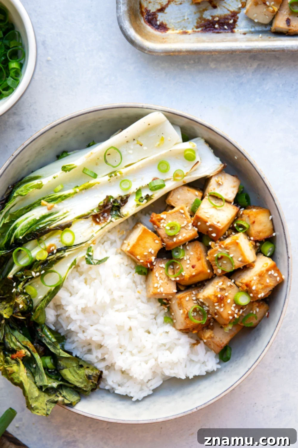 Savory Miso Tofu with Crisp Bok Choy 2 This miso baked tofu features tofu cubes marinated in a flavorful miso sauce and roasted alongside tender bok choy on one sheet pan. Serve this tofu and bok choy over hot rice with lots of sesame seeds and scallions!
