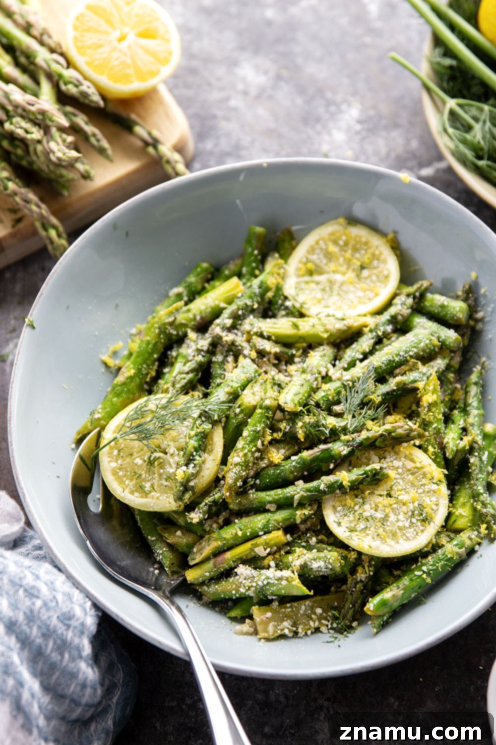 Bright Lemon Garlic Asparagus 3 Freshly cooked sautéed lemon garlic asparagus on a white plate, ready to serve.