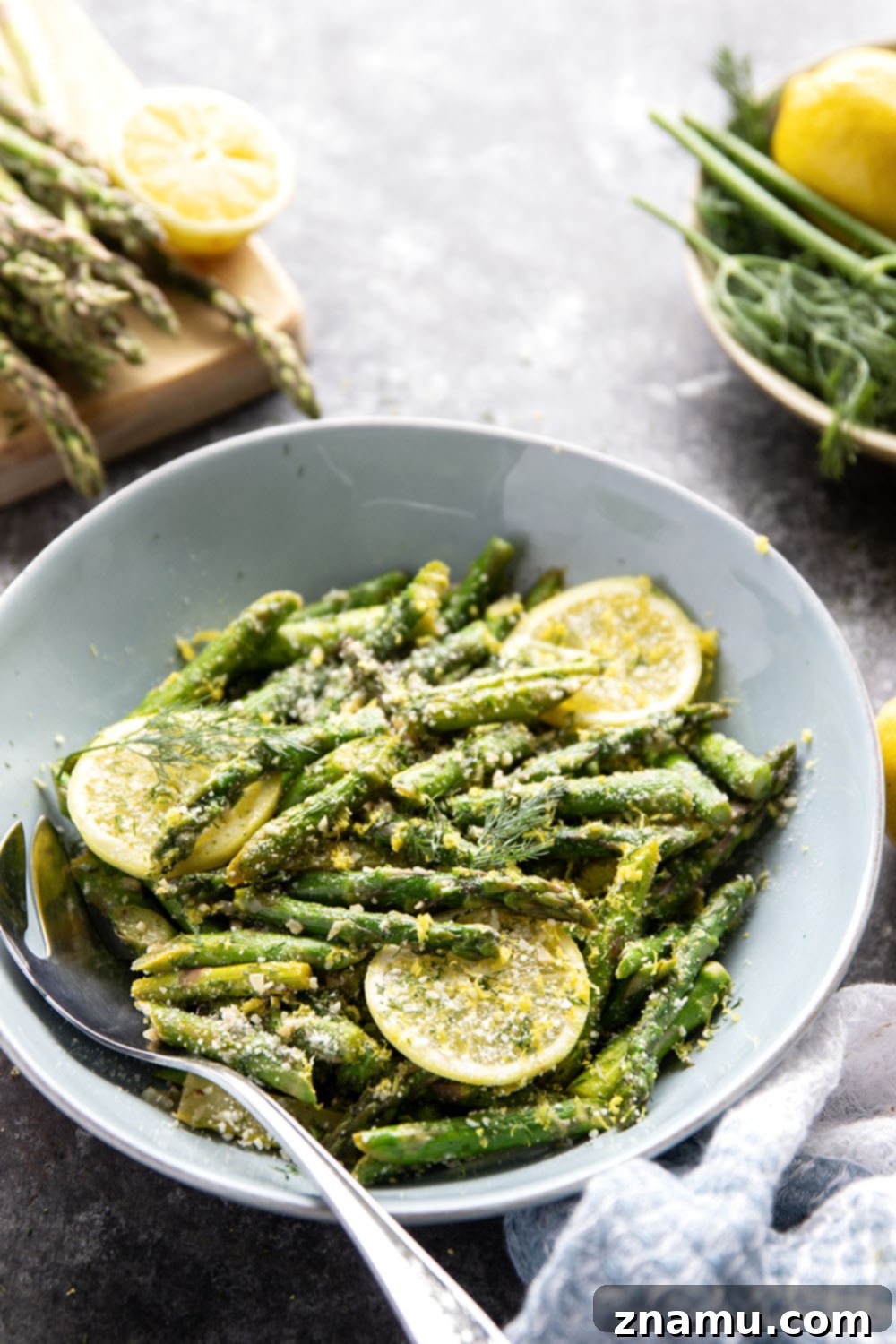 Bright Lemon Garlic Asparagus 6 A delicious serving of sautéed lemon garlic asparagus on a white plate, showcasing its vibrant green color.