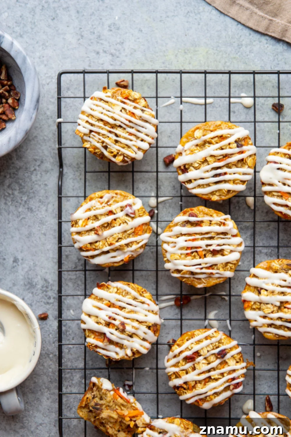 Breakfast Carrot Cake Oatmeal Cups 2 Delicious and healthy Carrot Cake Baked Oatmeal Cups with cream cheese glaze, perfect for breakfast or brunch.