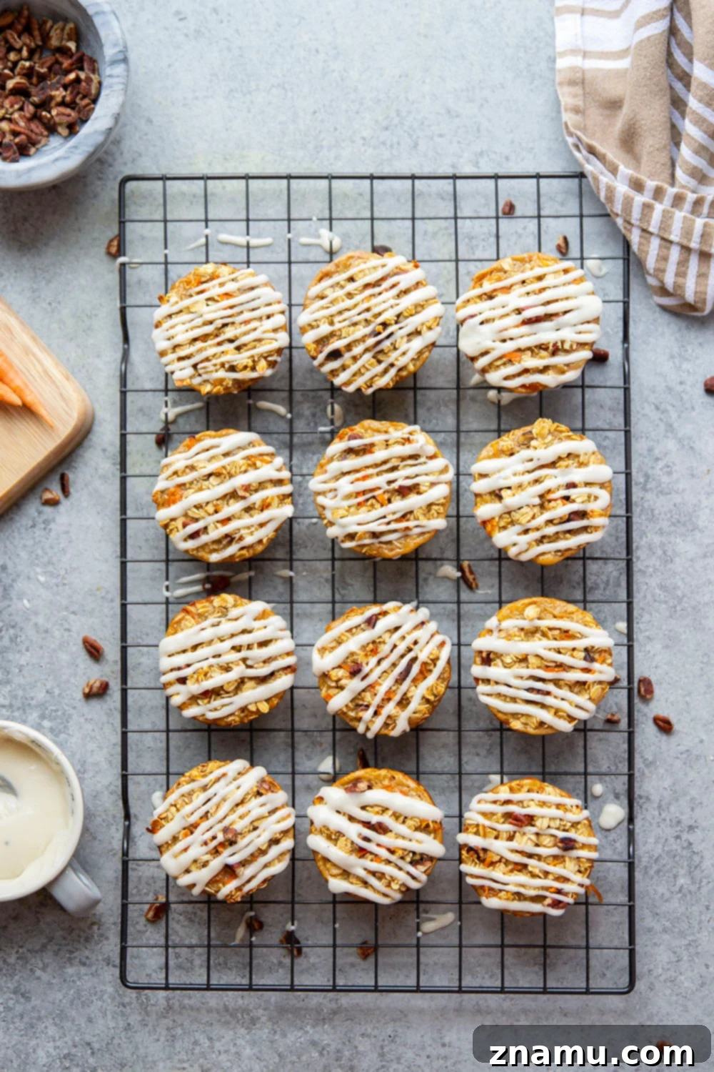 Breakfast Carrot Cake Oatmeal Cups 4 Three Carrot Cake Baked Oatmeal Cups stacked, showing their perfect muffin shape and creamy glaze, ideal for brunch.