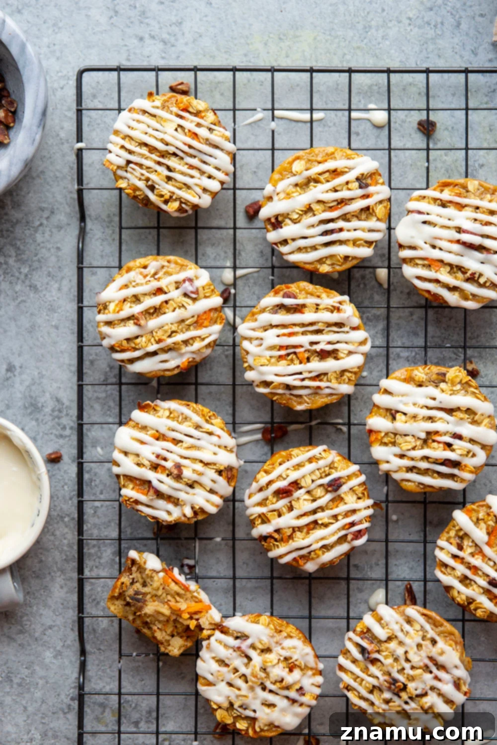 Breakfast Carrot Cake Oatmeal Cups 6 A close-up of a Carrot Cake Baked Oatmeal Cup with creamy glaze on a plate, ready to be enjoyed.