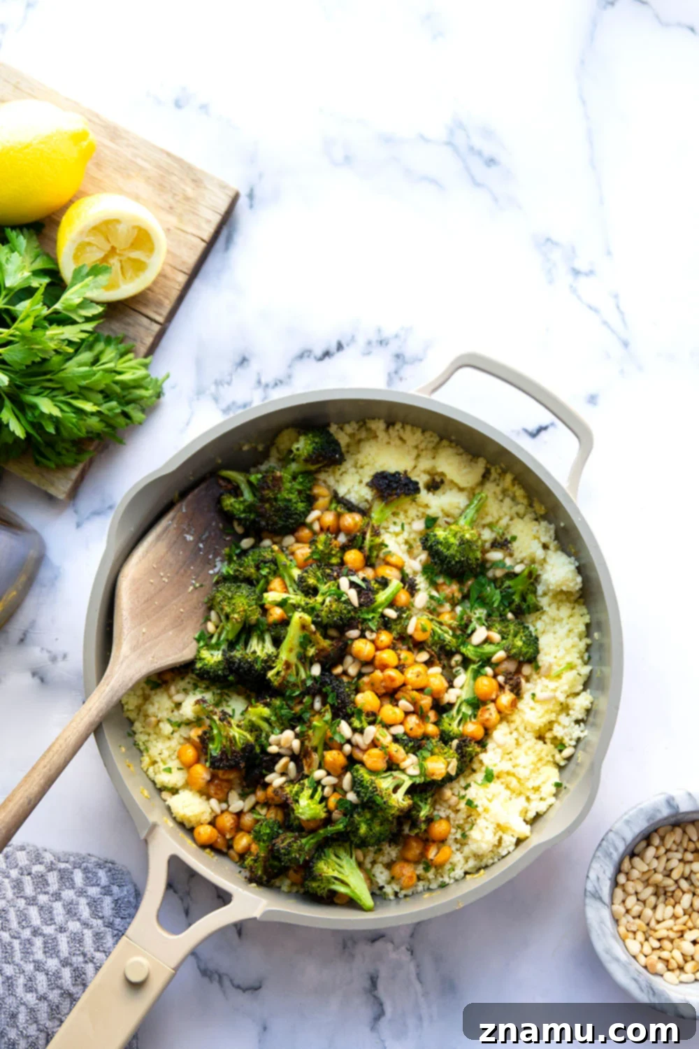 Zesty Lemon Couscous with Roasted Broccoli and Chickpeas 5 Ingredients for Lemon Couscous laid out, including fresh lemon, broccoli, chickpeas, and a bowl of couscous.