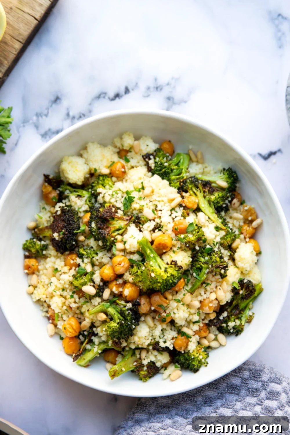 Zesty Lemon Couscous with Roasted Broccoli and Chickpeas 6 Plate of Lemon Couscous with roasted broccoli and chickpeas, garnished with fresh parsley.