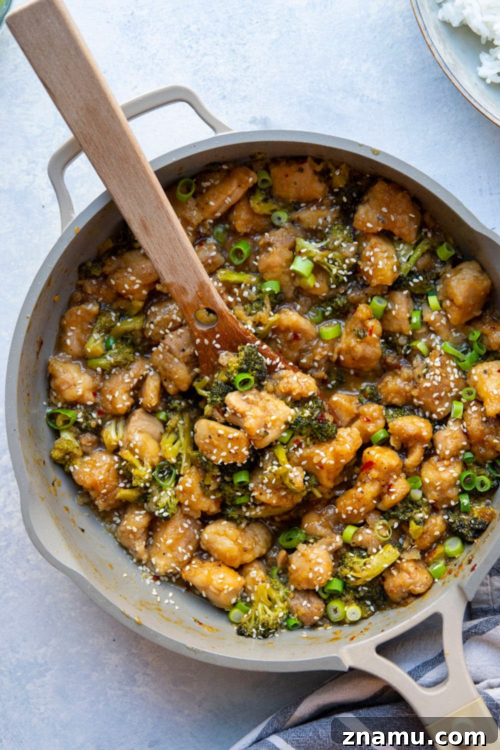 Sticky Honey Bourbon Chicken and Broccoli 6 Full plate of Honey Bourbon Chicken and Broccoli with rice, green onions, and sesame seeds, ready to be served.