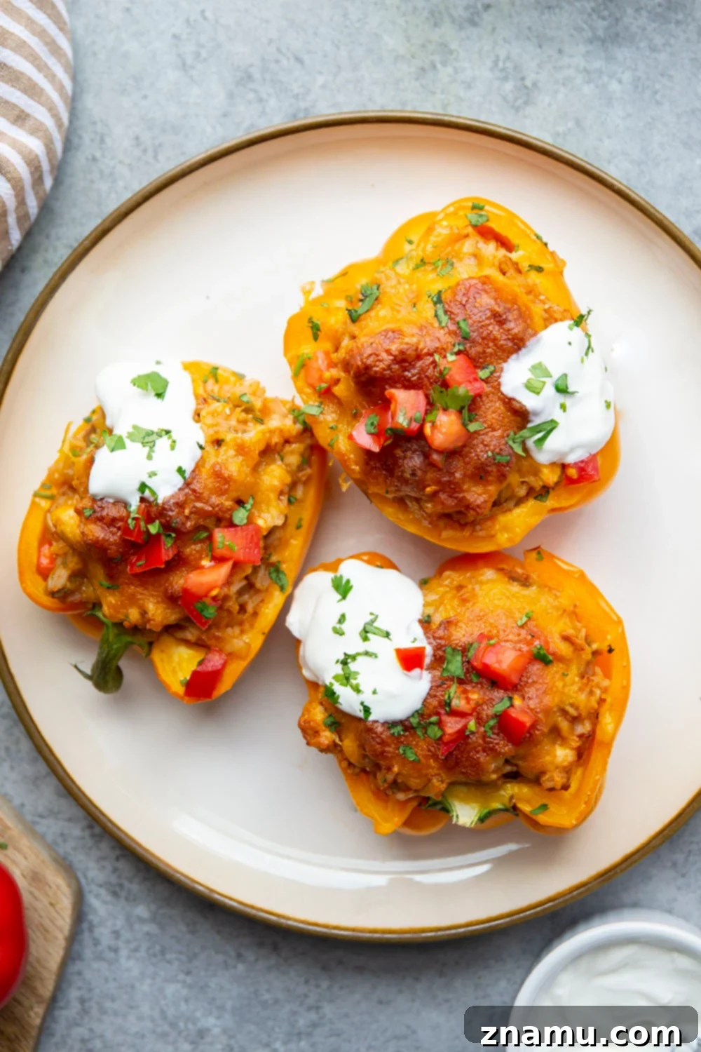 Enchilada Chicken Pepper Boats 4 Close-up view of the rich and cheesy chicken and rice filling inside a bell pepper.