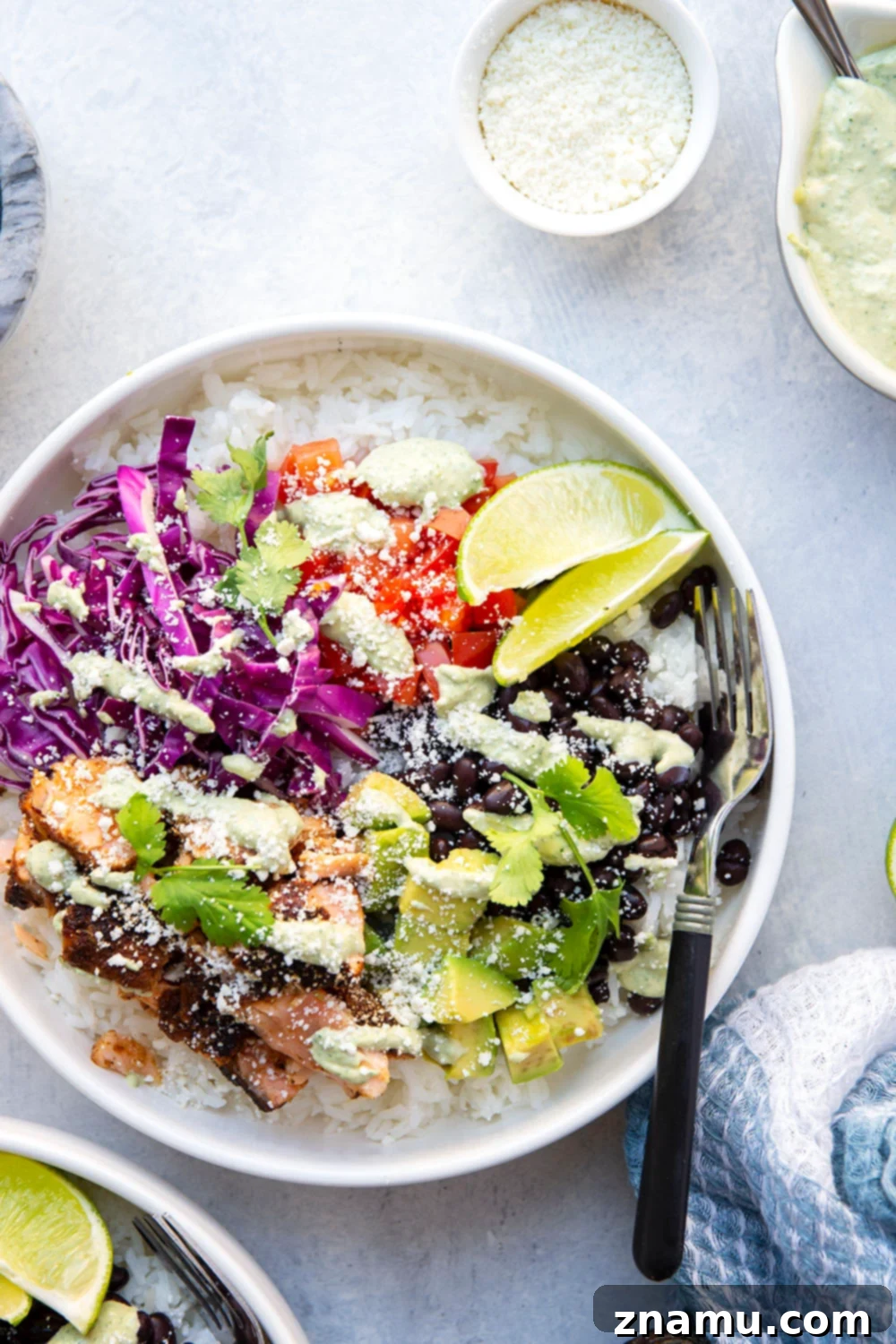 Fiesta Salmon Taco Bowls 2 These salmon taco bowls feature everything you love about a fish taco in rice bowl form! Loaded with lots of spicy blackened salmon, hearty rice, a creamy tahini cilantro sauce, and all your favorite toppings.