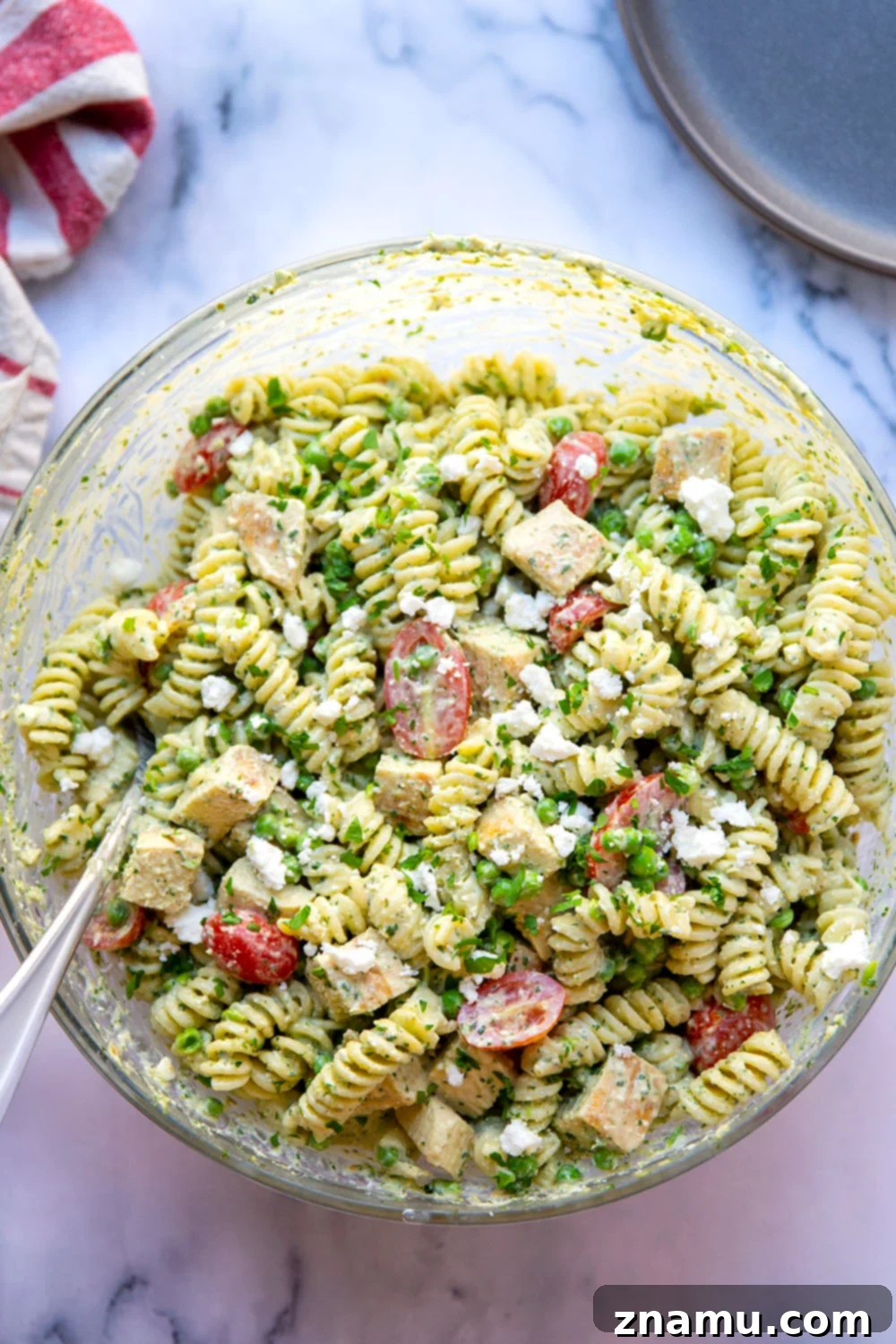 Green Goddess Pasta Salad: Feta & Grilled Chicken 3 Overhead view of a large bowl filled with colorful green goddess pasta salad, ready to be served.