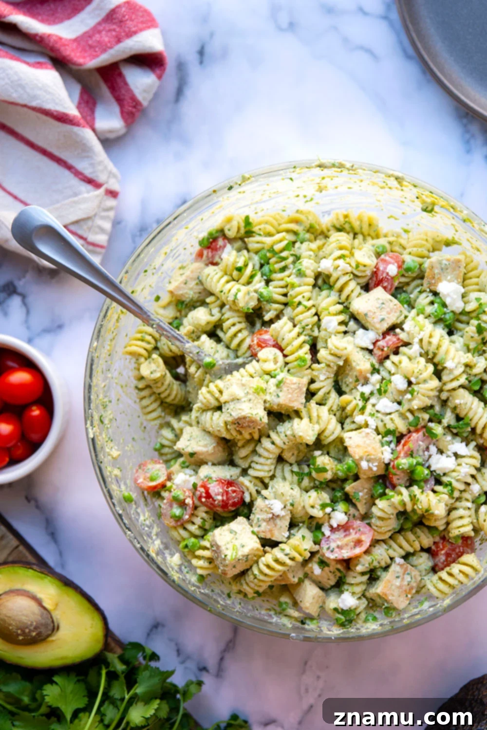 Green Goddess Pasta Salad: Feta & Grilled Chicken 6 A bowl of green goddess pasta salad, showcasing its creamy texture and fresh ingredients.