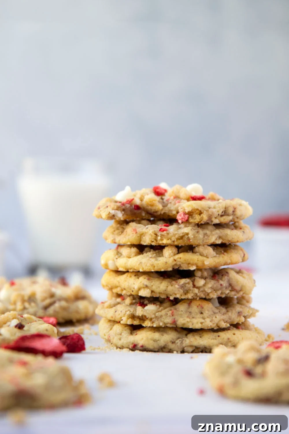 Strawberry White Chocolate Crumble Cookies 2 Delicious strawberry white chocolate cookies topped with streusel, stacked on a cooling rack.
