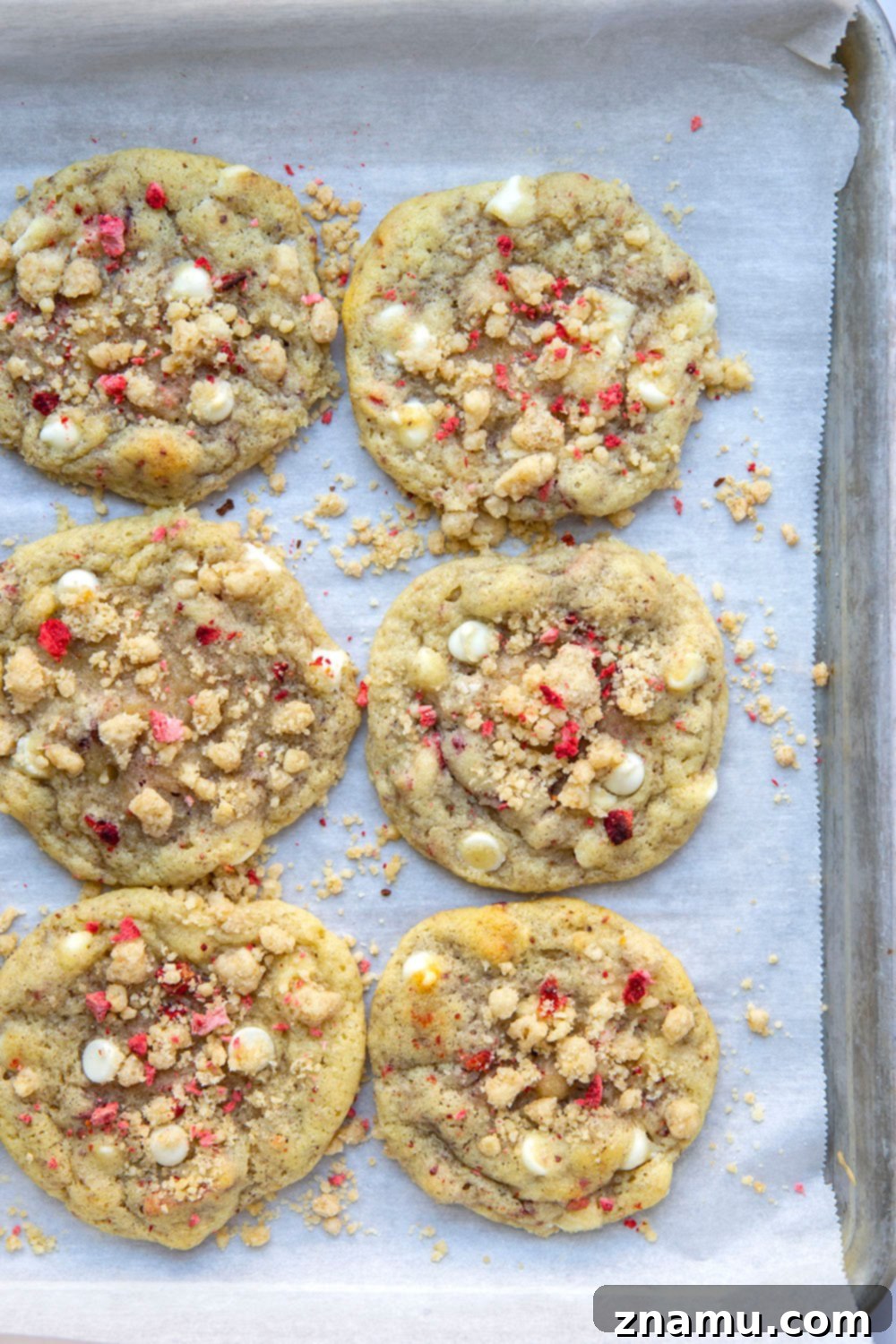 Strawberry White Chocolate Crumble Cookies 4 Several freshly baked strawberry white chocolate streusel cookies cooling on a wire rack.