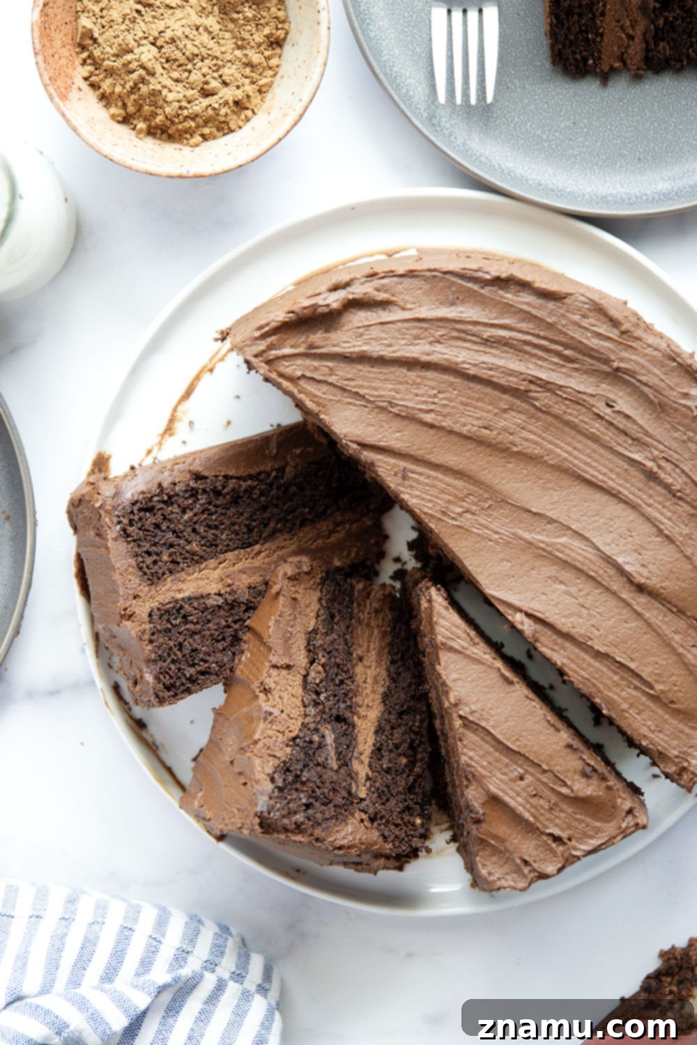 Decadent Chocolate Layer Cake 6 A generous slice of moist chocolate layer cake with rich buttercream on a plate, ready to be enjoyed.
