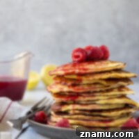 Fluffy Lemon Cottage Cheese Pancakes with Raspberry Drizzle 8 A stack of golden lemon cottage cheese pancakes with raspberry syrup