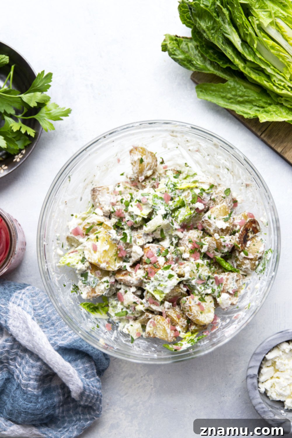 Mediterranean Tzatziki Potato Salad 3 This Greek tzatziki potato salad features tender herb-roasted potatoes dressed with homemade tzatziki sauce and tossed with lots of crisp lettuce, crumbly feta, and pickled red onions.
