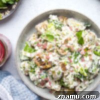 Mediterranean Tzatziki Potato Salad 8 This Greek tzatziki potato salad features tender herb-roasted potatoes dressed with homemade tzatziki sauce and tossed with lots of crisp lettuce, crumbly feta, and pickled red onions.