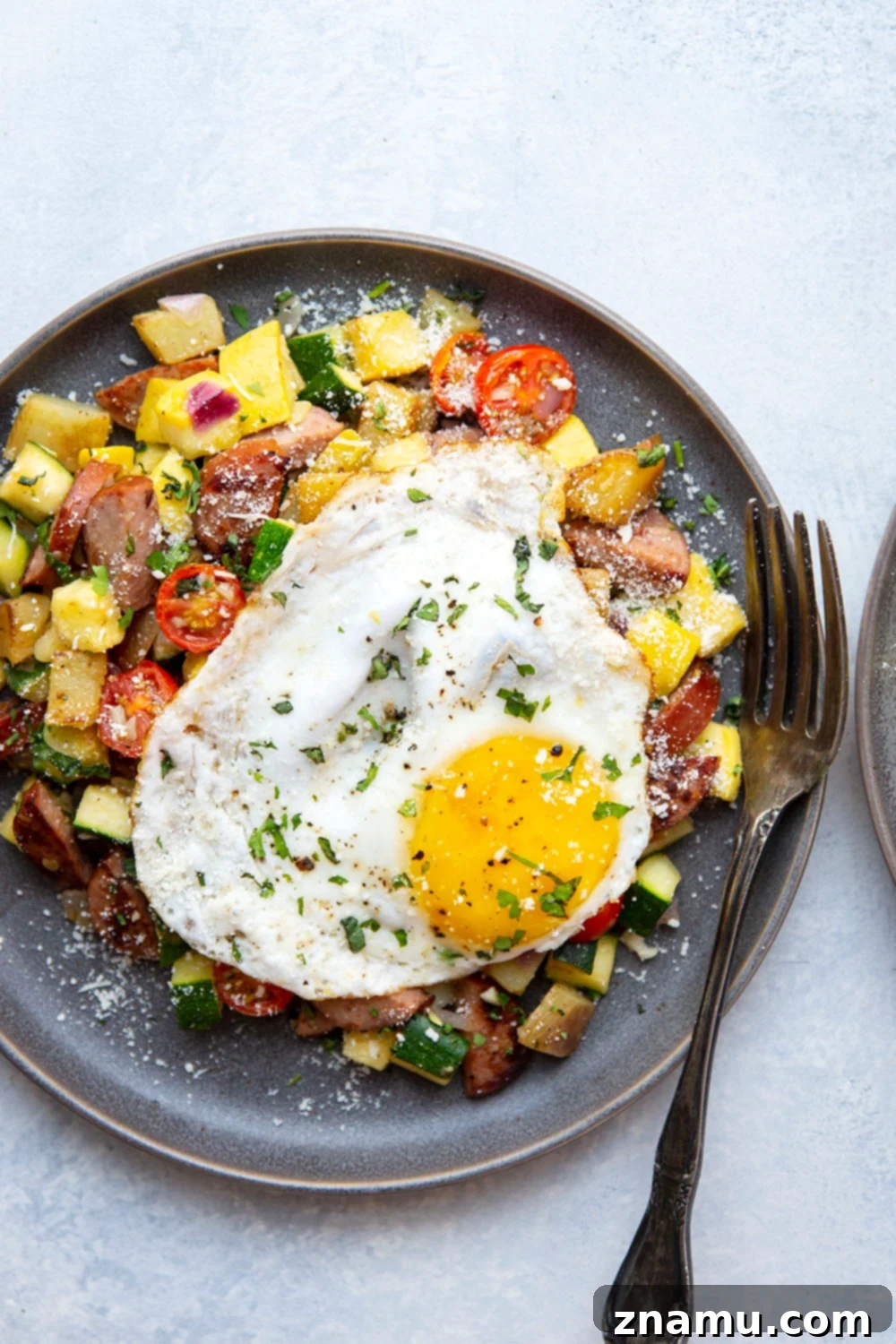 Summer Harvest Sausage Hash 4 This sausage breakfast hash is loaded with a rainbow of fresh summer vegetables, crispy potatoes, and lots of flavorful sausage. - the best savory summer breakfast with an egg served on top!