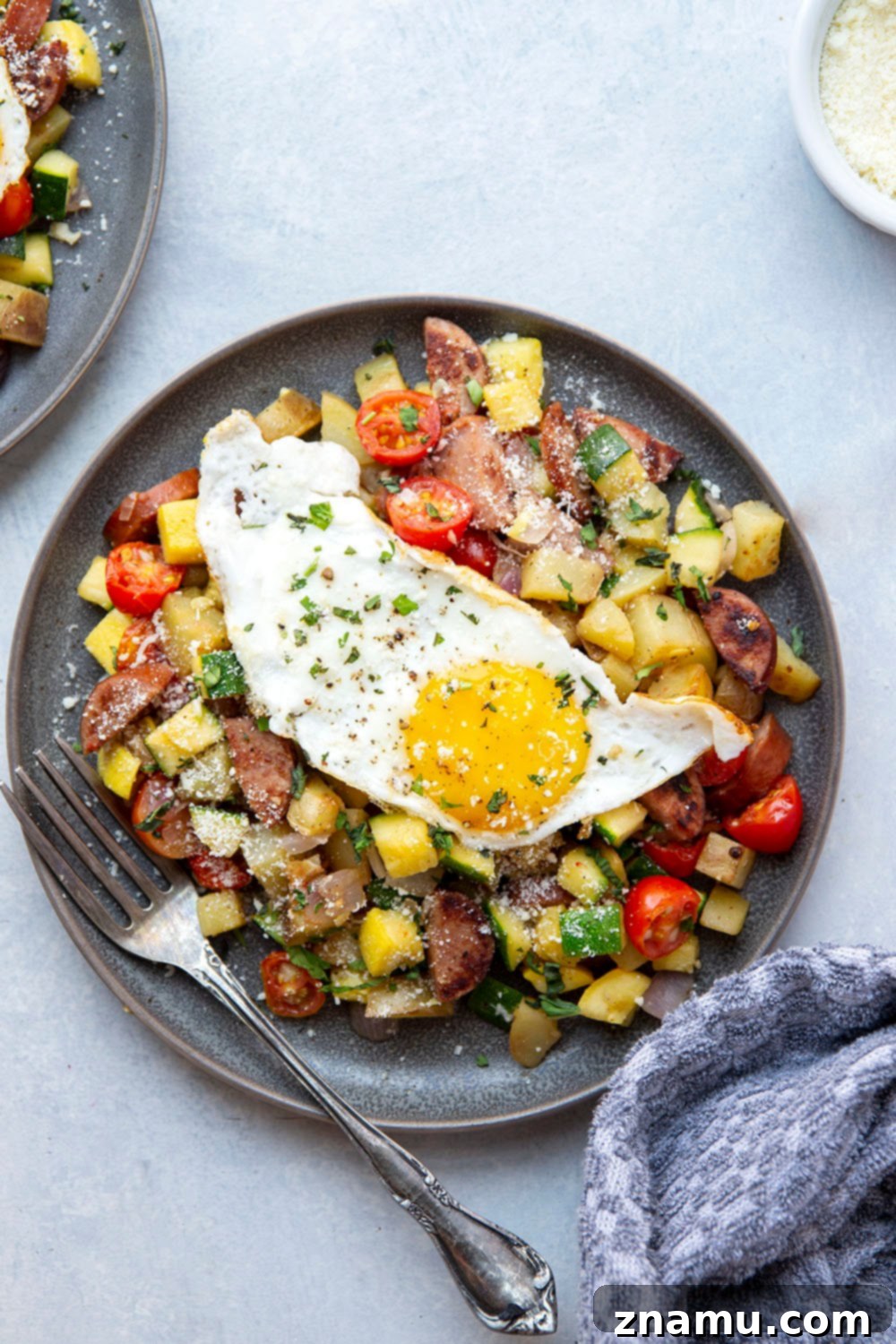 Summer Harvest Sausage Hash 6 This sausage breakfast hash is loaded with a rainbow of fresh summer vegetables, crispy potatoes, and lots of flavorful sausage. - the best savory summer breakfast with an egg served on top!
