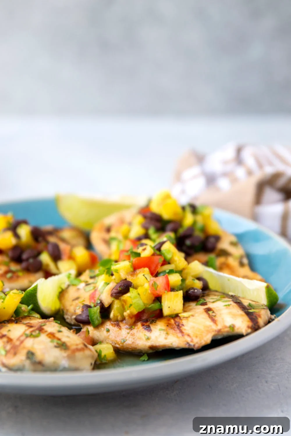Pineapple Grilled Chicken with Fresh Black Bean Salsa 3 Close-up shot of pineapple grilled chicken with black bean salsa, showcasing the vibrant colors and textures.