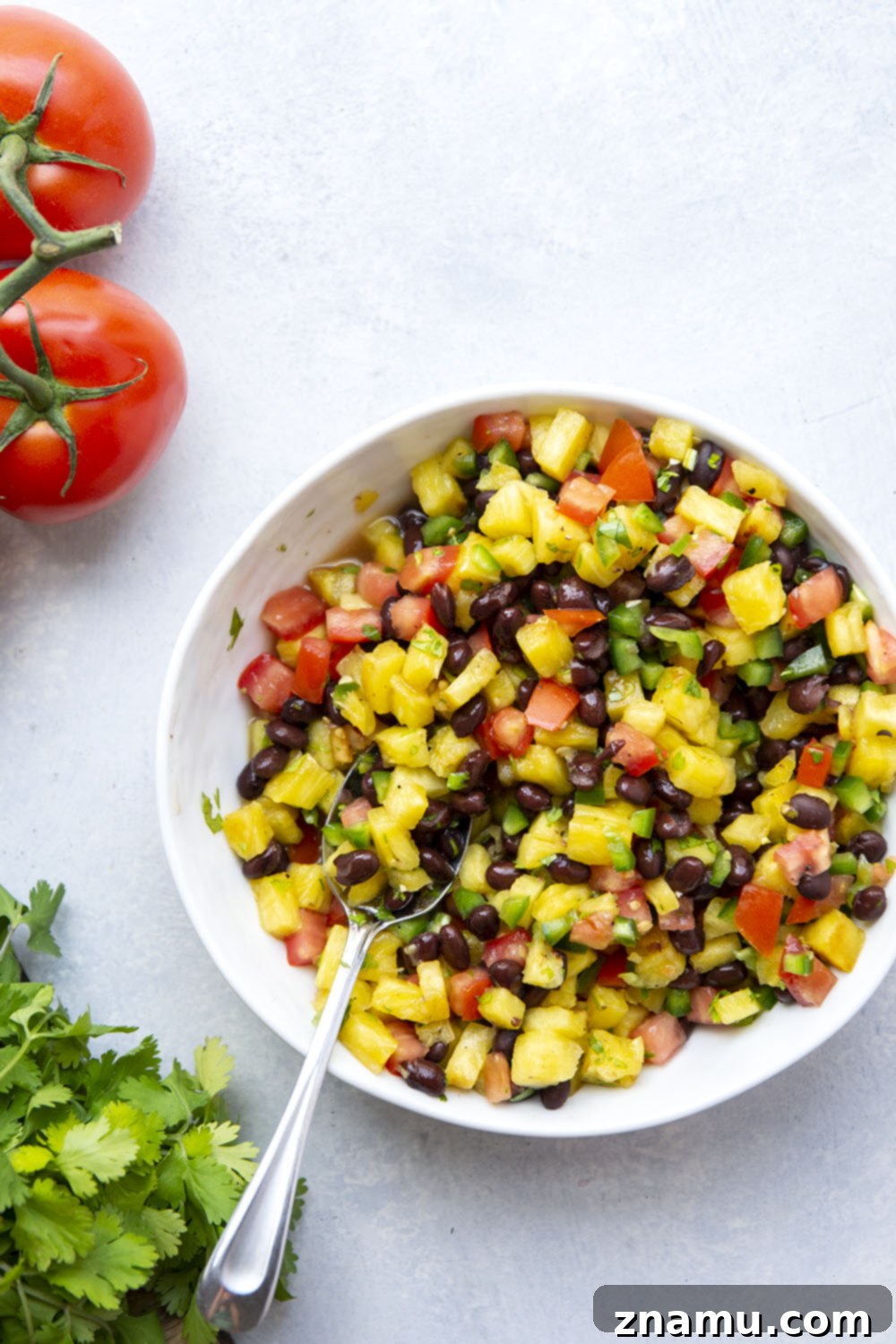 Pineapple Grilled Chicken with Fresh Black Bean Salsa 4 Planks of fresh pineapple grilling alongside marinated chicken breasts, showing grill marks.