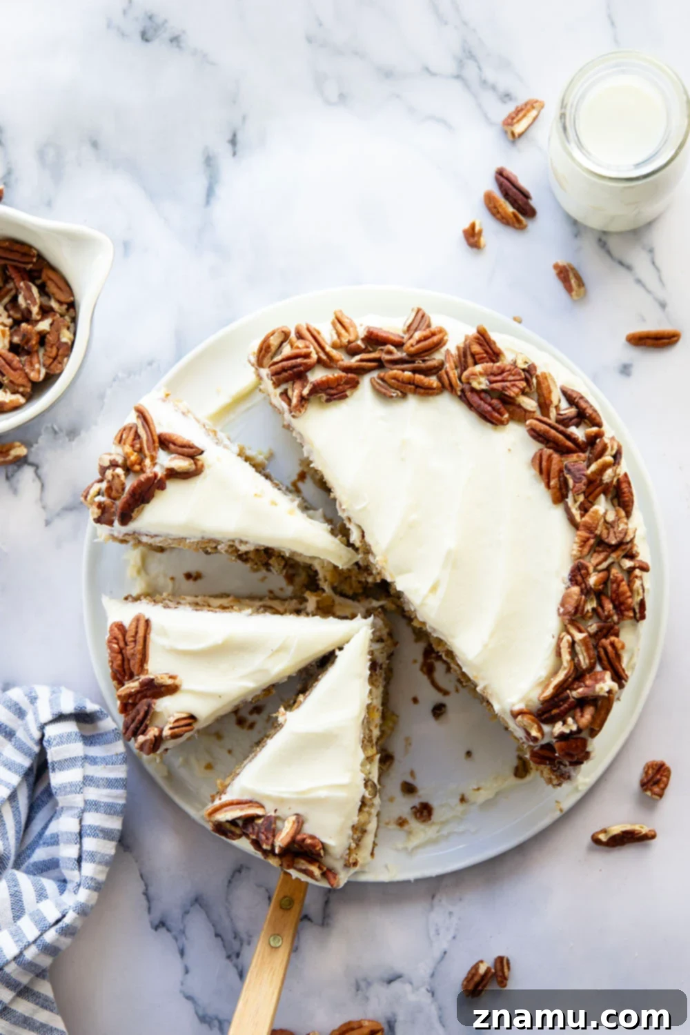 Taste of the Tropics, Southern Style 6 A slice of Hummingbird Cake on a white plate, showcasing the layered texture and rich cream cheese frosting.