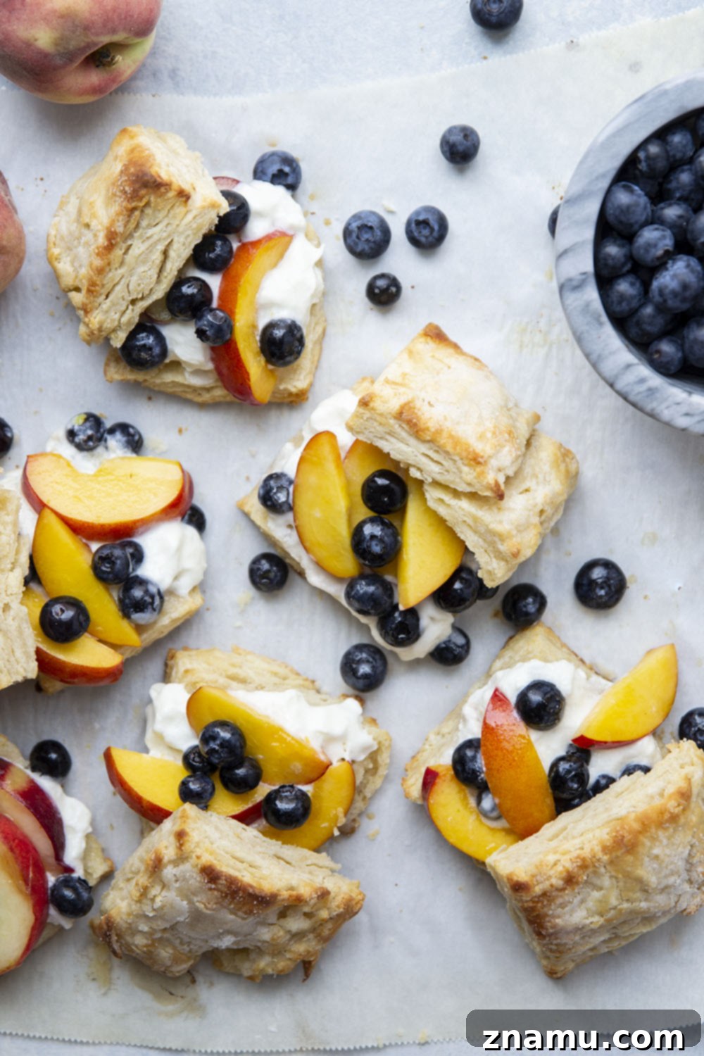 Sun-Drenched Peach Berry Dream 3 A vibrant and appealing blueberry peach shortcake, showcasing the harmonious blend of golden biscuits, sweet peaches, ripe blueberries, and rich whipped cream. A quintessential summer dessert.