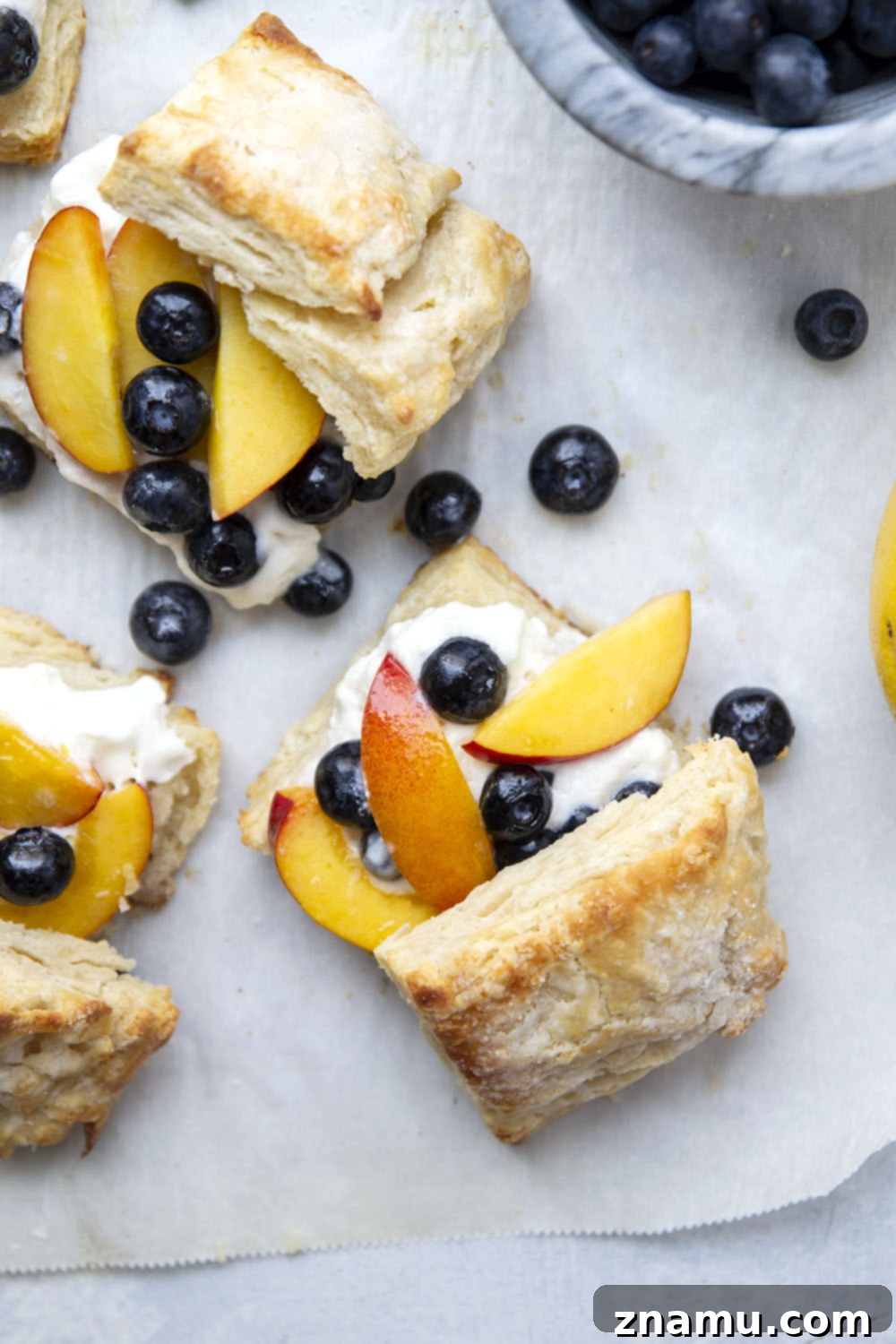 Sun-Drenched Peach Berry Dream 6 Two servings of homemade blueberry peach shortcake, beautifully plated with ample whipped cream, highlighting the rich colors and textures of a perfect summer dessert.