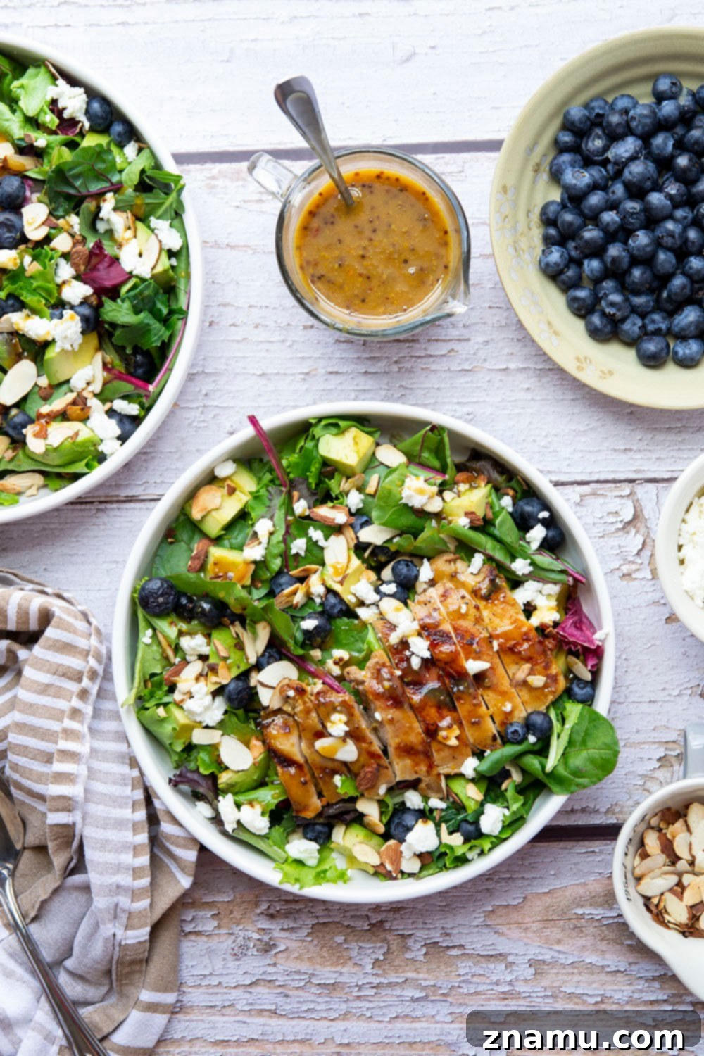 This salad features juicy grilled chicken thighs brushed with homemade honey mustard and tossed in a big green salad with fresh blueberries and avocado.