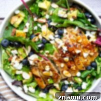 This salad features juicy grilled chicken thighs brushed with homemade honey mustard and tossed in a big green salad with fresh blueberries and avocado.