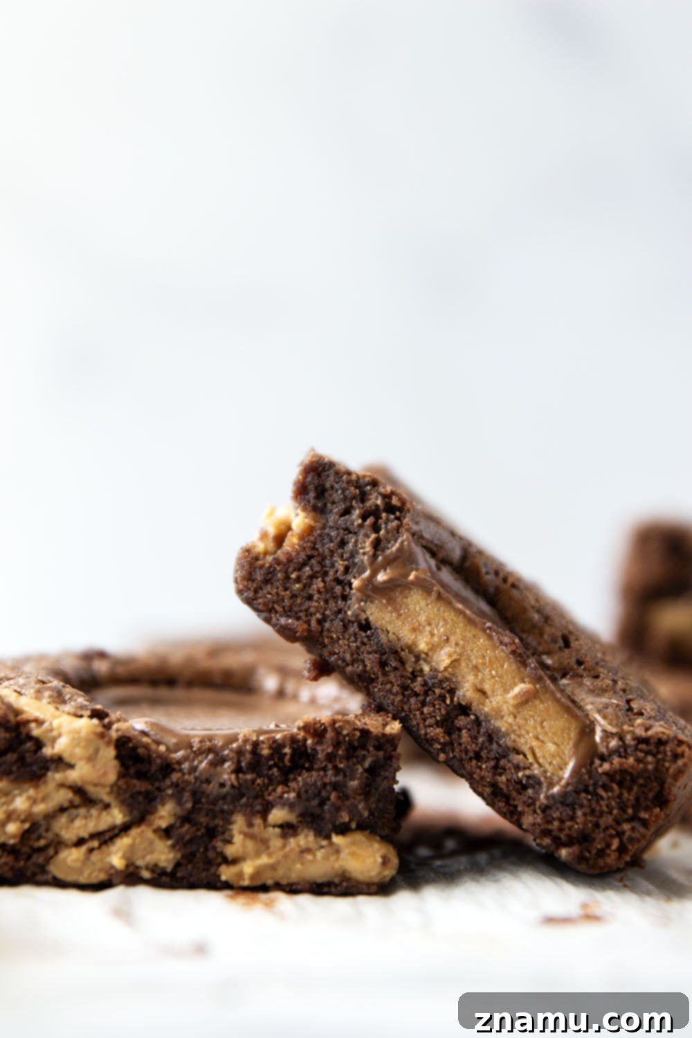 Swirled Peanut Butter Chocolate Brownies 6 A stack of perfectly cut peanut butter swirl brownies on a plate, ready to be enjoyed.