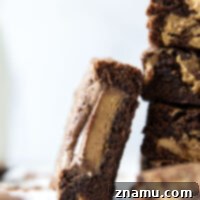 Swirled with creamy peanut butter and topped with lots of peanut butter cups, these fudgy peanut butter swirl brownies are the ultimate dessert for any peanut butter lover!