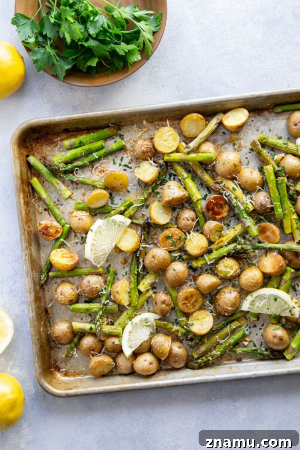 Bright Lemon Roasted Asparagus and Potatoes 3 Roasted baby potatoes and tender asparagus spears glistening with lemon garlic butter.