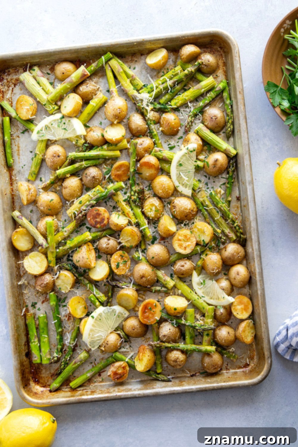Bright Lemon Roasted Asparagus and Potatoes 5 A vibrant mix of lemon garlic roasted potatoes and asparagus on a serving plate.