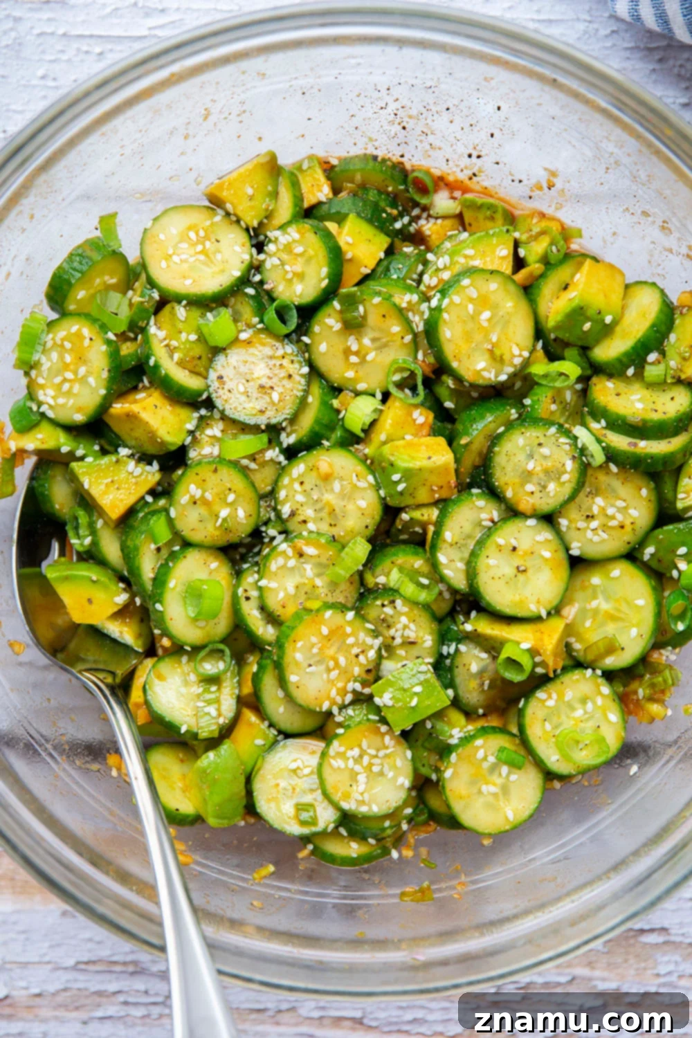 Vibrant Asian Cucumber Avocado Medley 5 Ingredients for the gochujang vinaigrette - soy sauce, rice wine vinegar, honey, gochujang, and sesame oil - being whisked in a bowl.