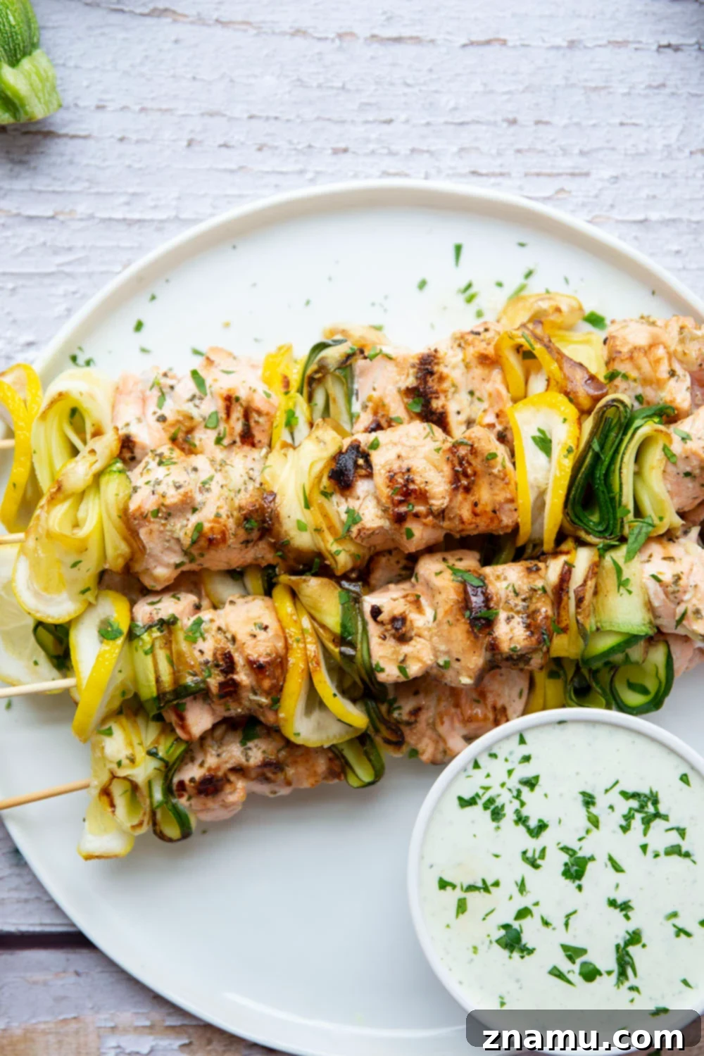 Mediterranean Salmon Skewers with Whipped Feta 5 Raw salmon and zucchini on skewers, ready for grilling.