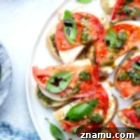 Fresh Basil Pesto Caprese Bruschetta 8 Layered with juicy tomatoes, fresh mozzarella, and a flavorful homemade basil pesto, this bruschetta is the easiest appetizer to whip up and always a hit!